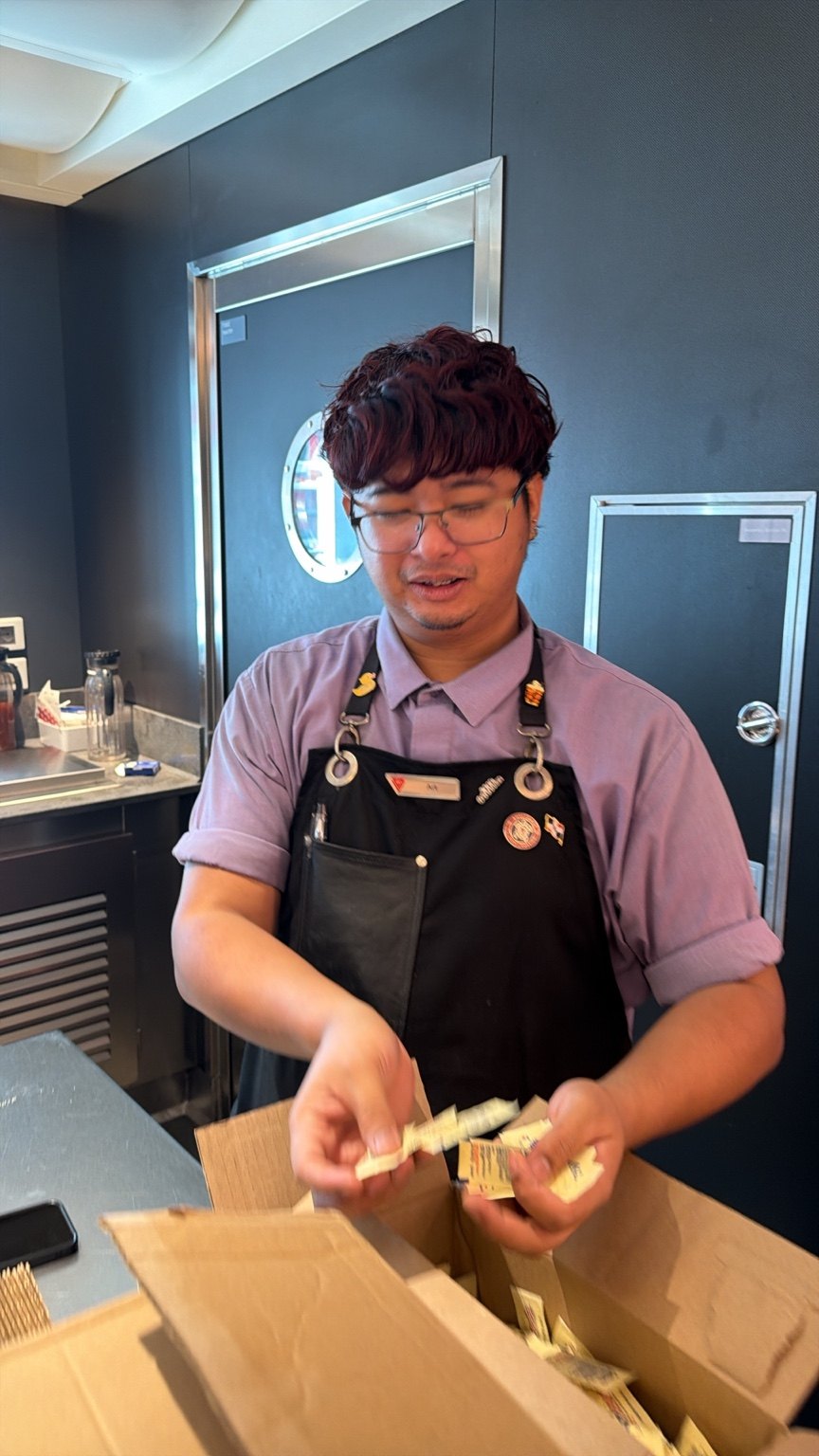 A crew member preparing food at a counter
