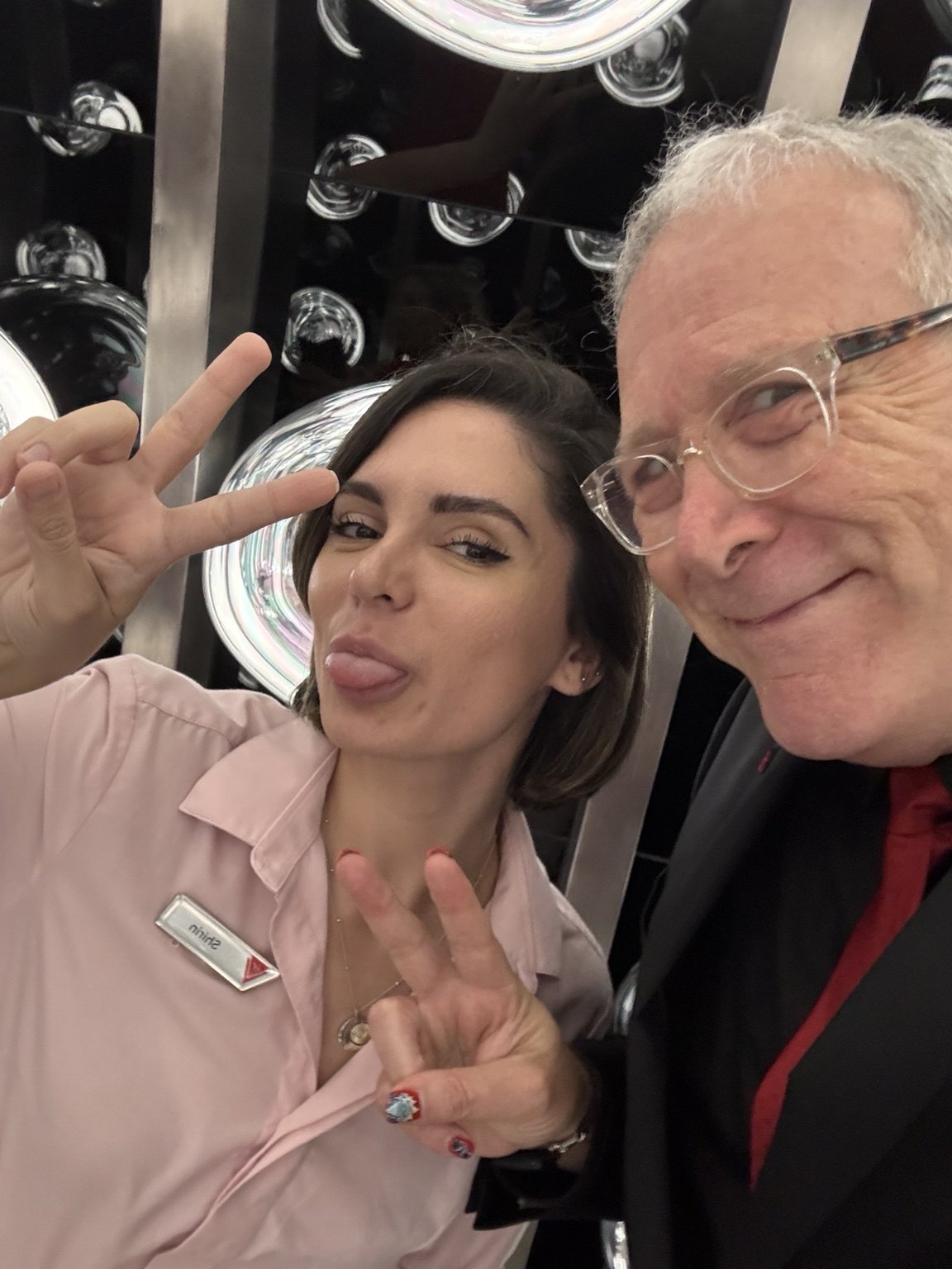 Mark and a crew member posing beside a mirror
