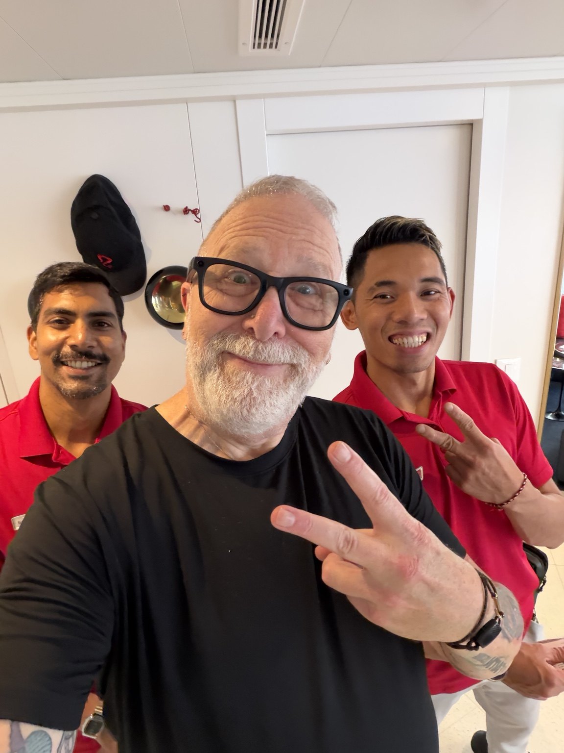 Mark posing with two crew members in red uniforms